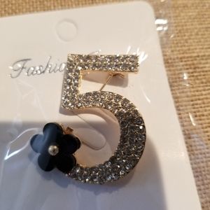 Number 5 pin with black daisy channel